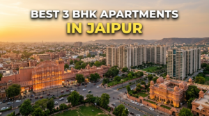 Alt Text: > Aerial view of Jaipur skyline at sunset showing the Hawa Mahal and traditional pink architecture blended with modern high-rise residential apartments, featuring bold overlay text that reads "BEST 3 BHK APARTMENTS IN JAIPUR" with a strong drop shadow.